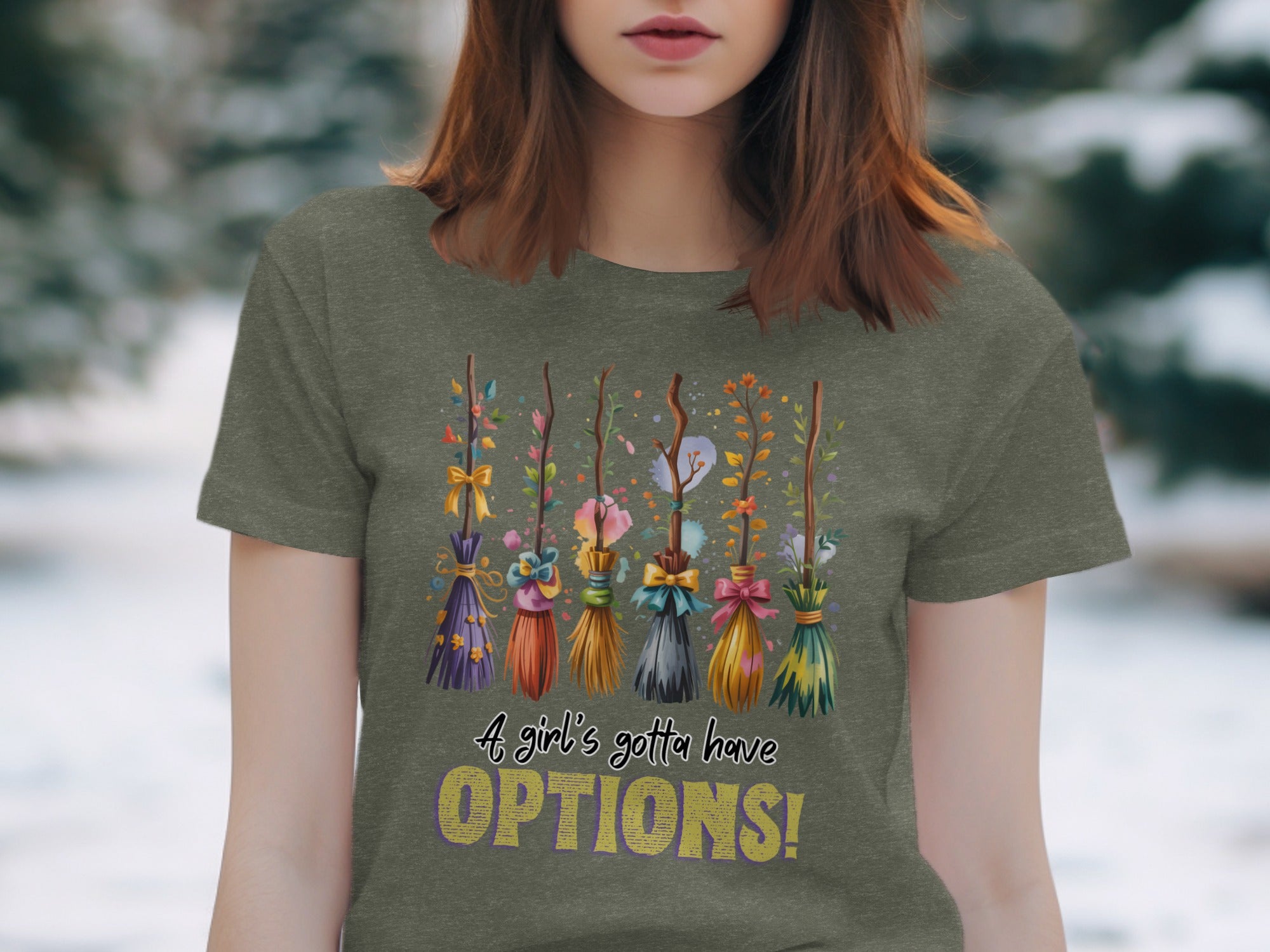 T-shirt graphic with decorative brooms and text "A girl's gotta have OPTIONS!".