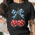 Black t-shirt with patriotic cherries and star-spangled bow graphic.