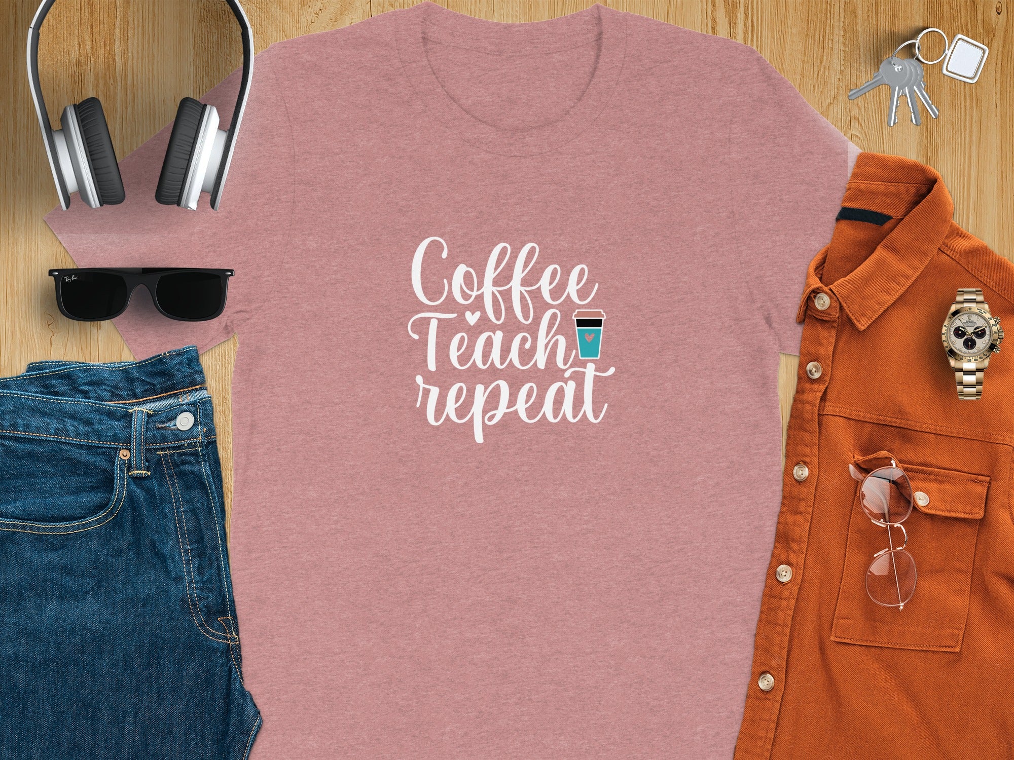 Dusty rose t-shirt with "Coffee Teach repeat" graphic and coffee cup icon.