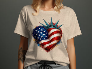 Heart-shaped American flag graphic with Statue of Liberty crown on t-shirt.