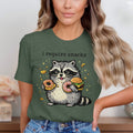 T-shirt graphic of a raccoon holding donuts and a burger, with "i require snacks" text above.