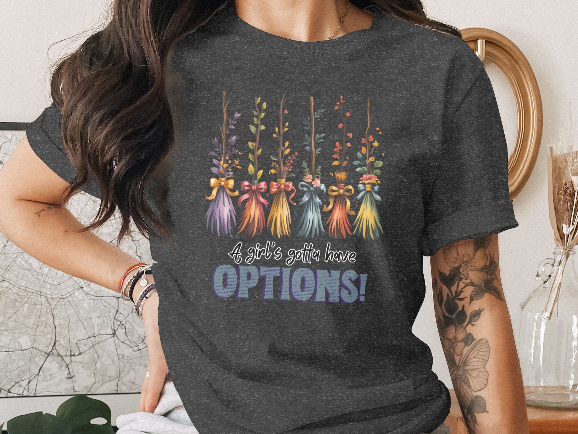 Dark grey t-shirt with floral brooms and text "A girl's gotta have OPTIONS!".