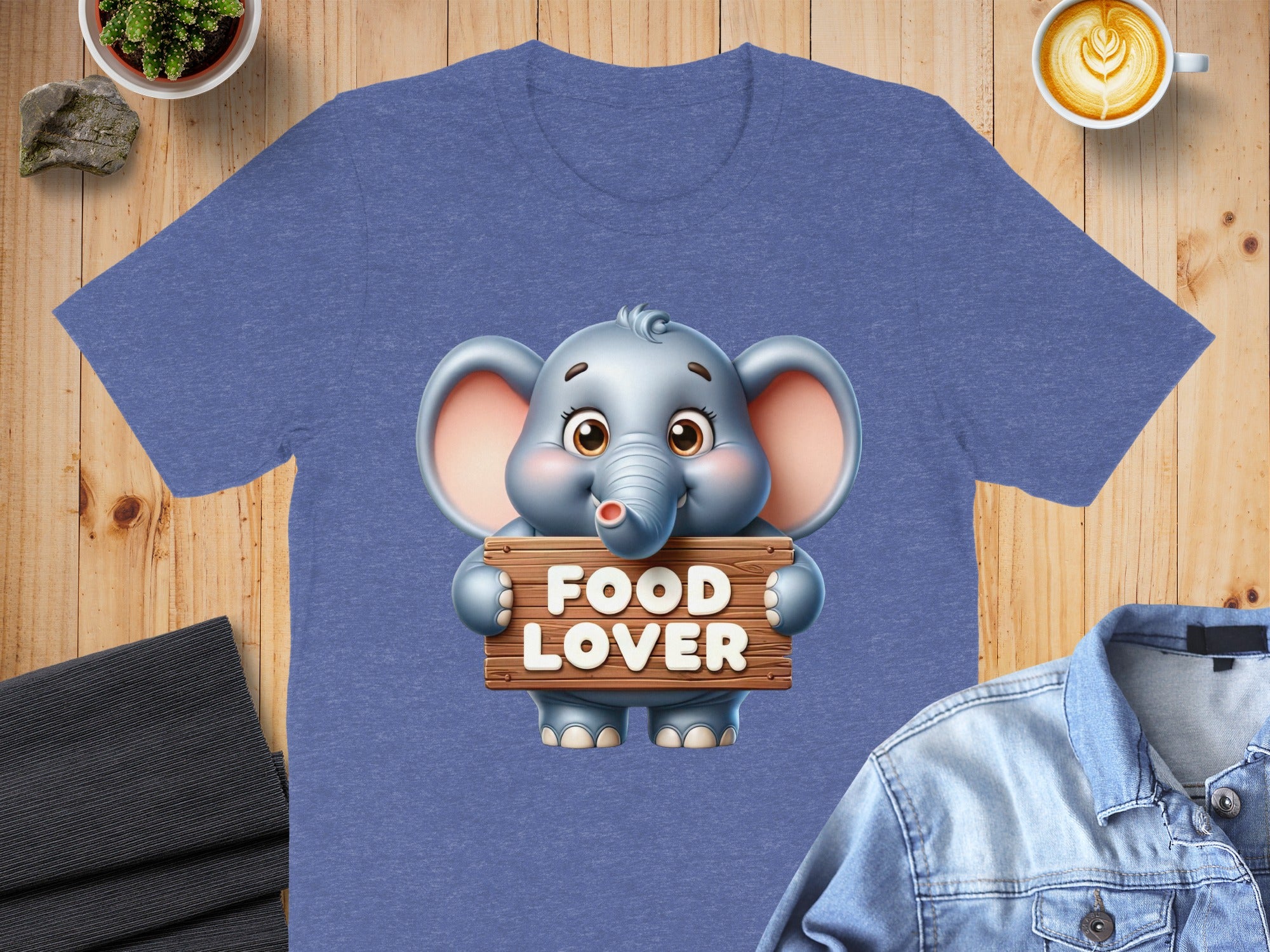 Cute elephant holding a "FOOD LOVER" sign on a blue t-shirt.