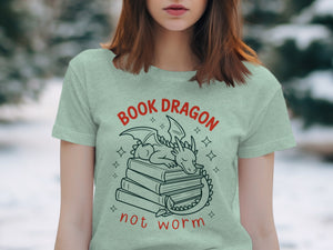 Light green t-shirt with "Book Dragon not worm" text and sleeping dragon on books graphic.