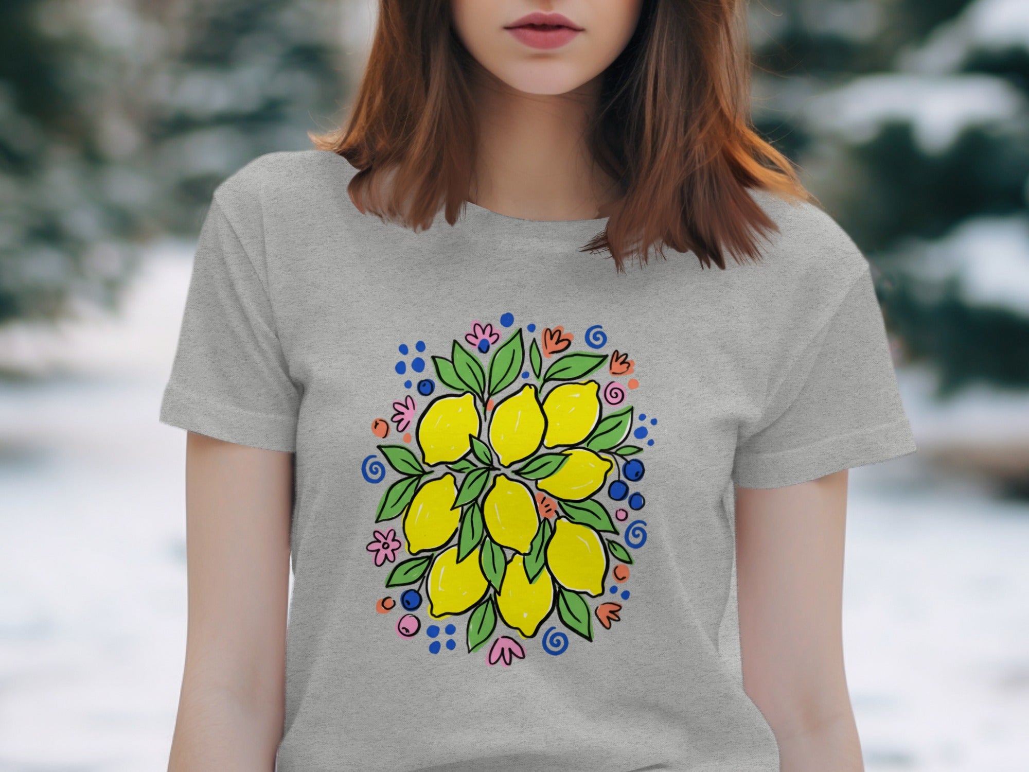 Grey t-shirt with a vibrant lemon, leaf, and floral print centered on chest.