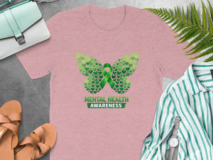 Pink t-shirt with butterfly made of green hearts and "Mental Health Awareness" text.