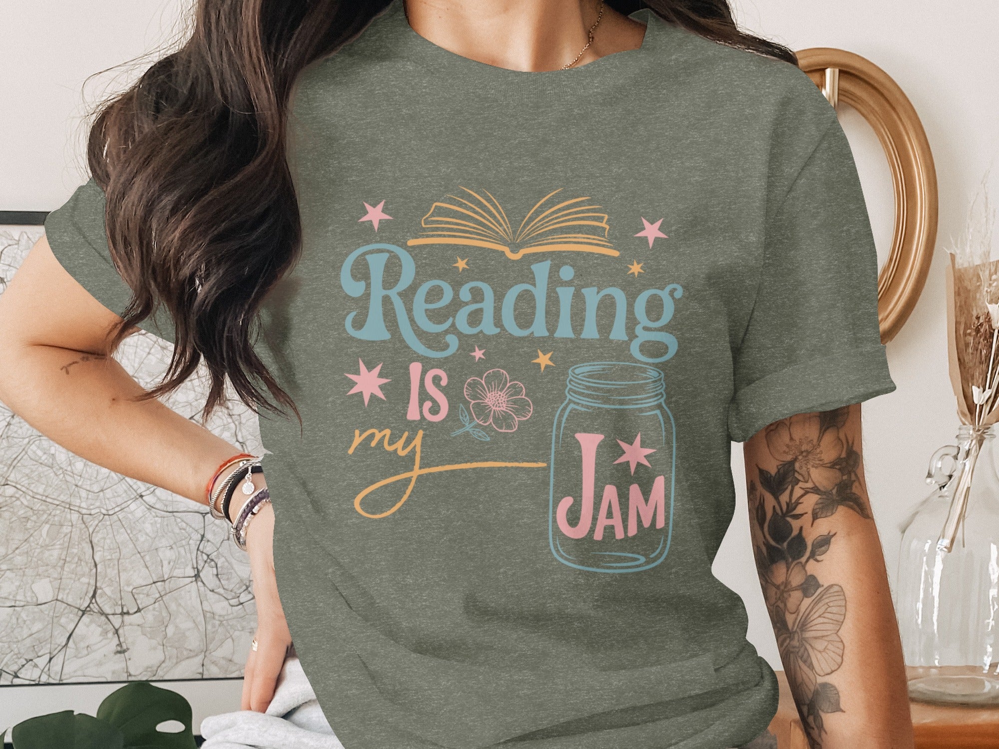 Green t-shirt with "Reading Is My Jam" text, an open book, and a mason jar graphic.