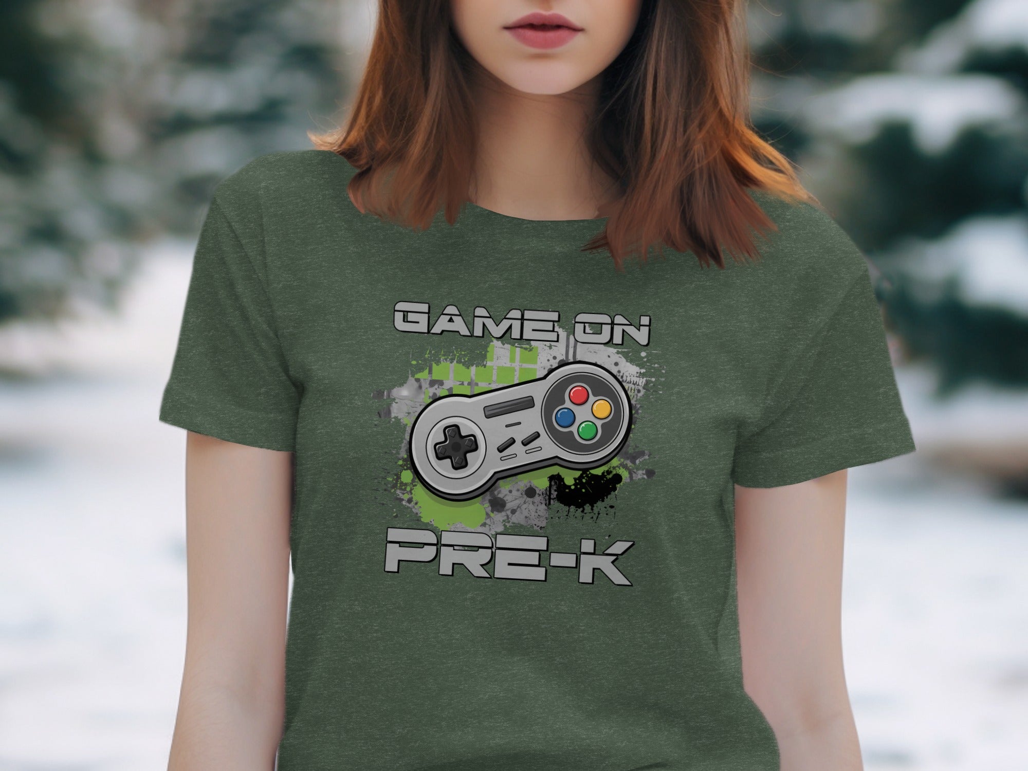 Green t-shirt with "GAME ON PRE-K" text and a retro video game controller graphic.