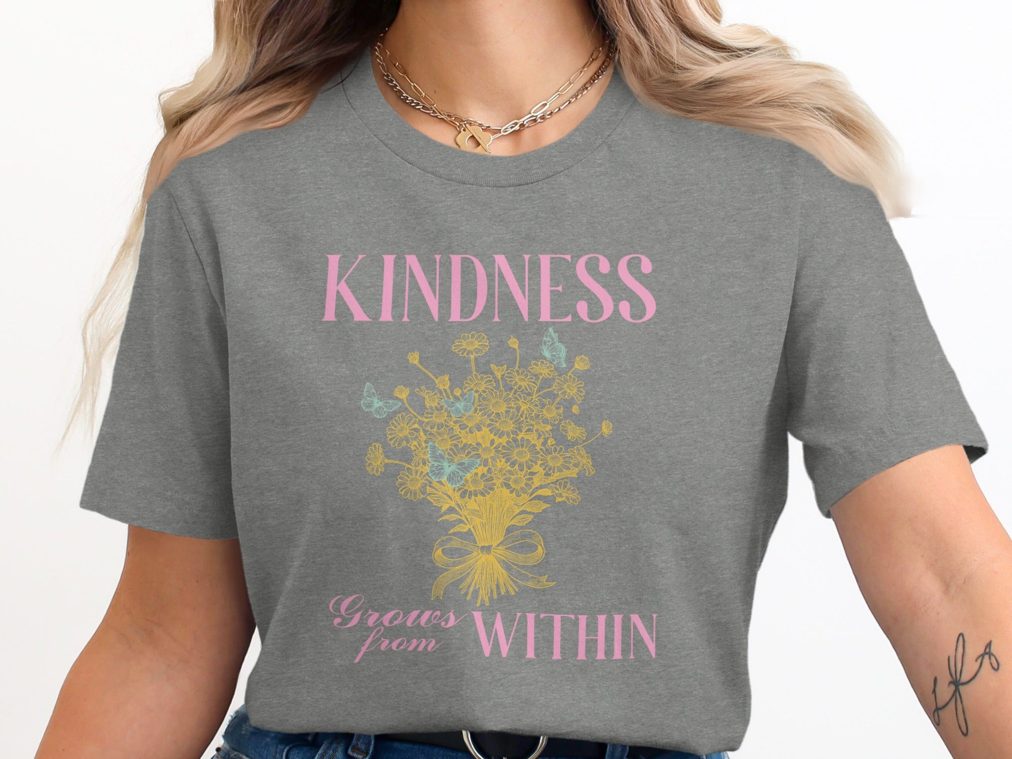 Grey t-shirt with "KINDNESS Grows from WITHIN" and floral butterfly graphic.