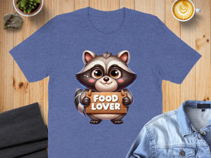 Cartoon raccoon holding a "FOOD LOVER" wooden sign on a t-shirt.