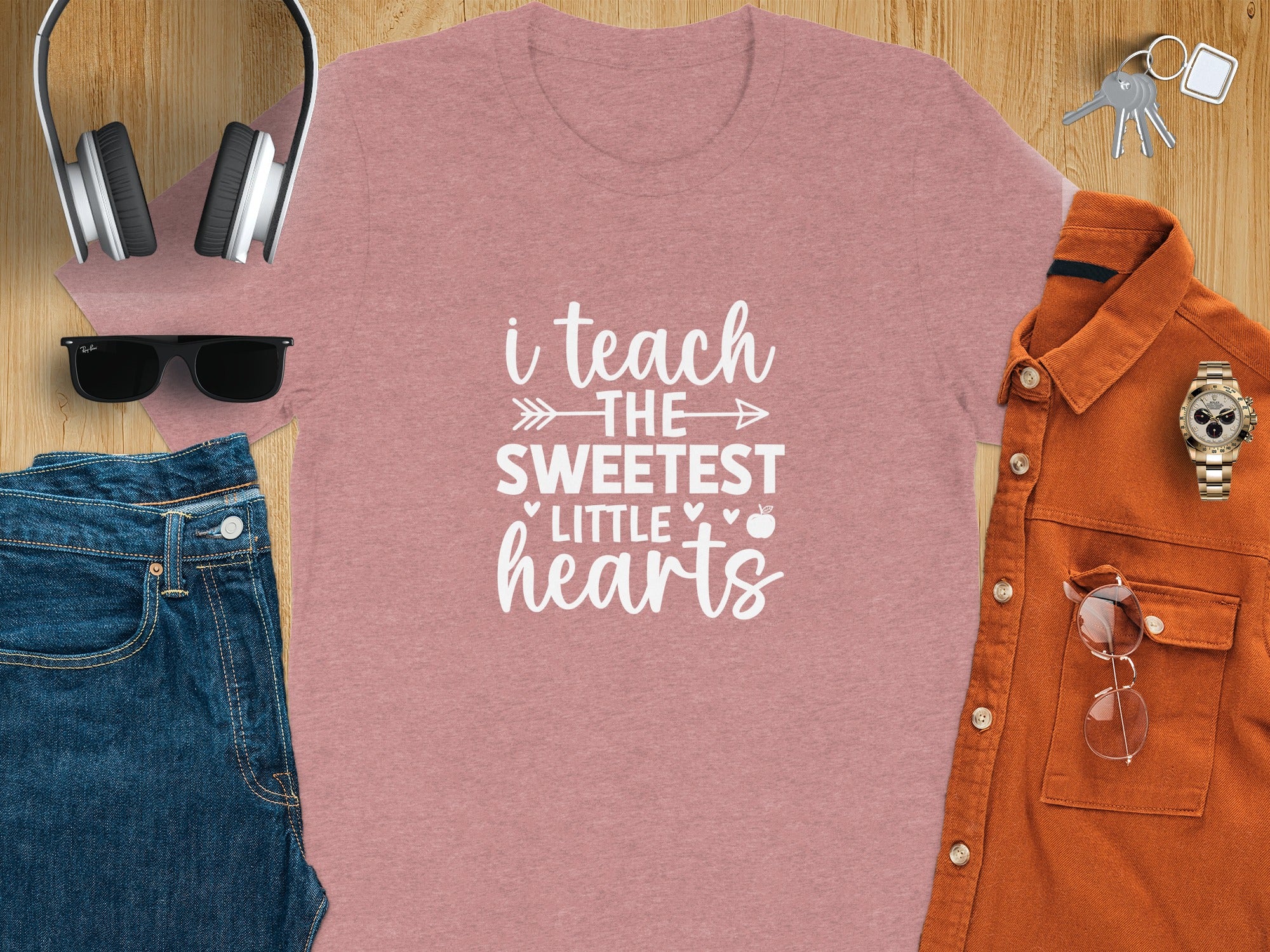 Pink t-shirt with white text: "i teach THE SWEETEST LITTLE hearts"