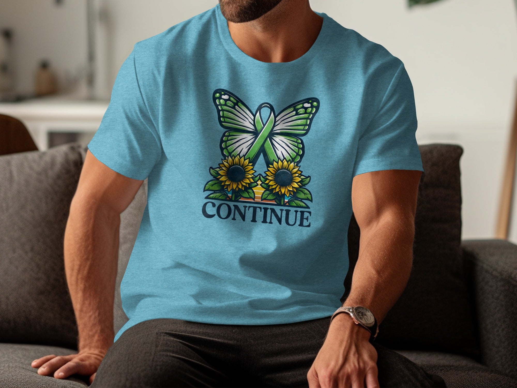 Turquoise t-shirt with green ribbon butterfly, sunflowers, and the word CONTINUE.