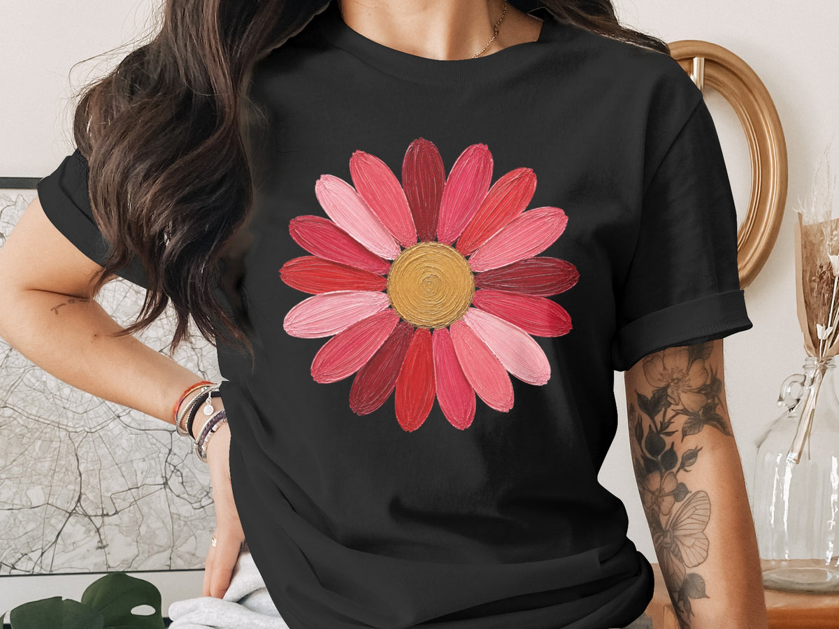 Black t-shirt with a pink and red flower graphic and gold center.