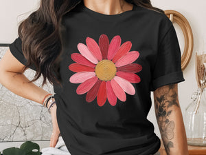 Black t-shirt with a pink and red flower graphic and gold center.