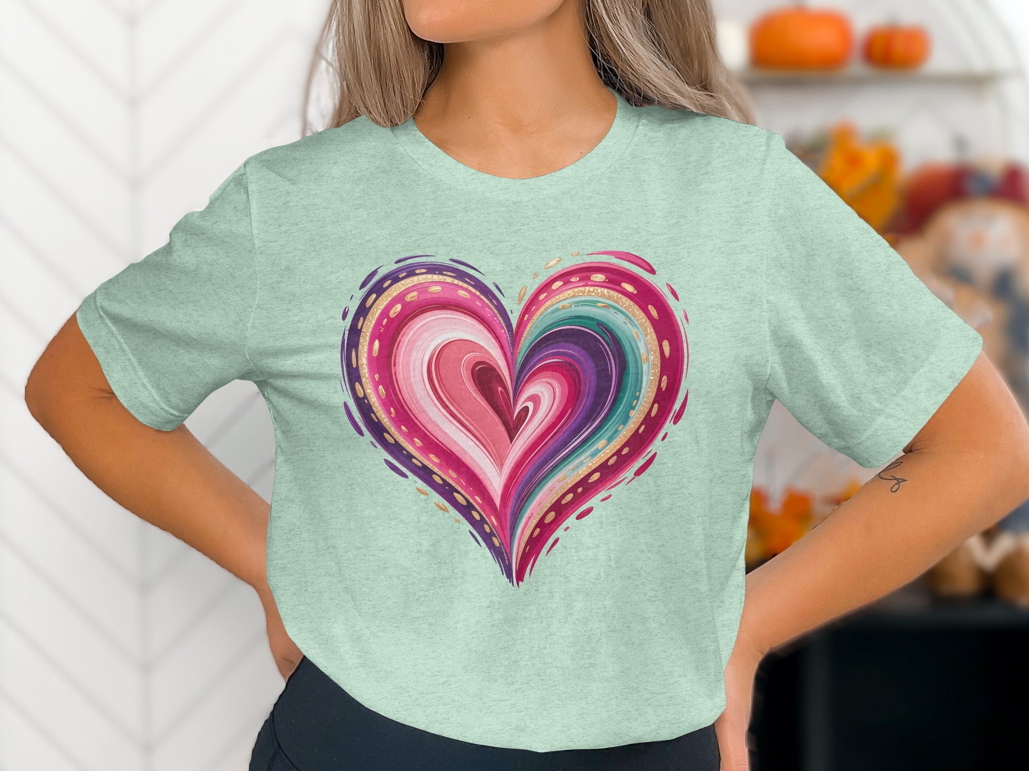 Mint t-shirt with colorful abstract heart design and gold accents.