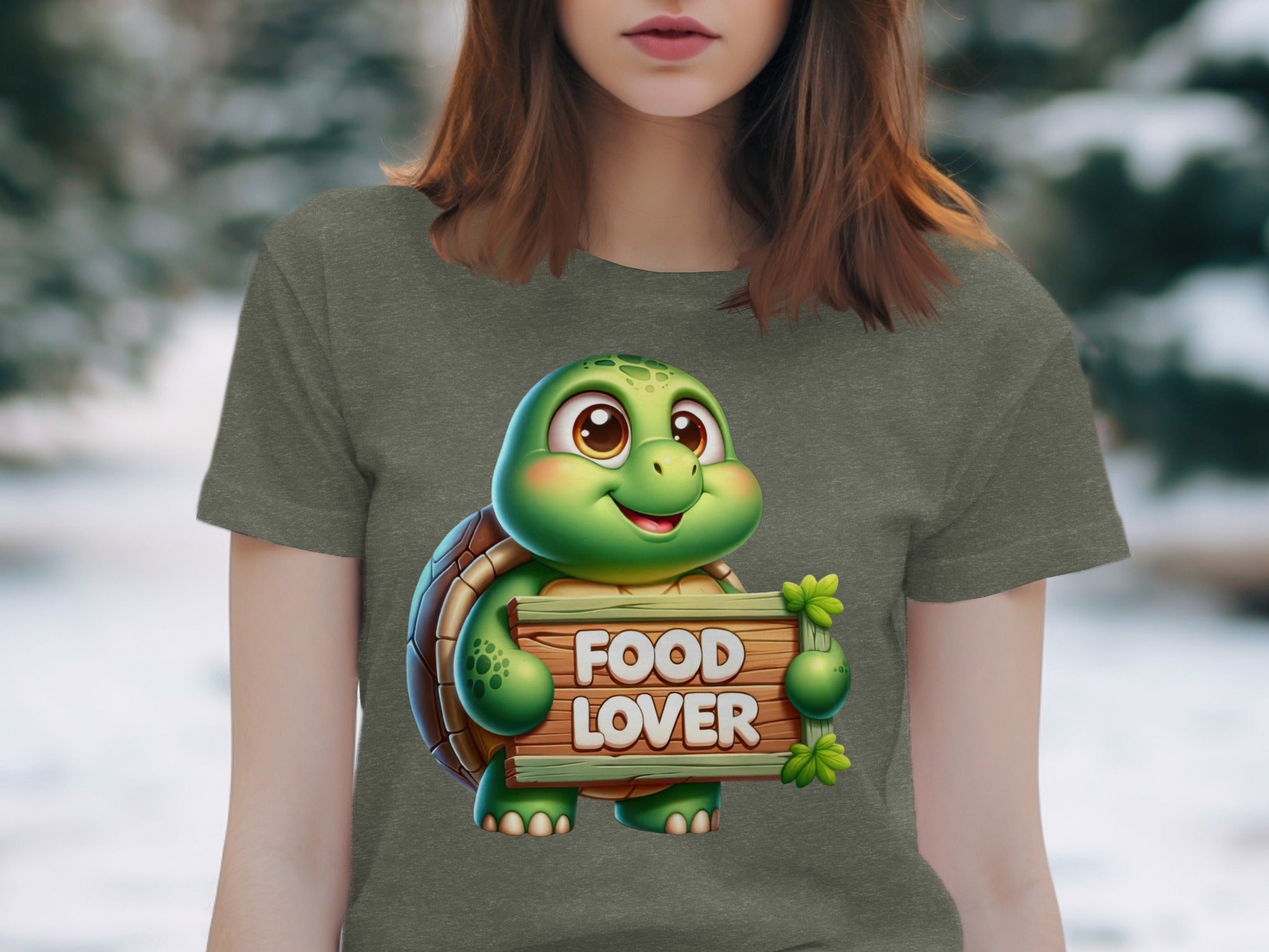 Cartoon turtle holding sign with text "FOOD LOVER" on a t-shirt.