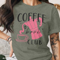 Green t-shirt with pink coffee pot, cup, and "Coffee & Book Club" text.