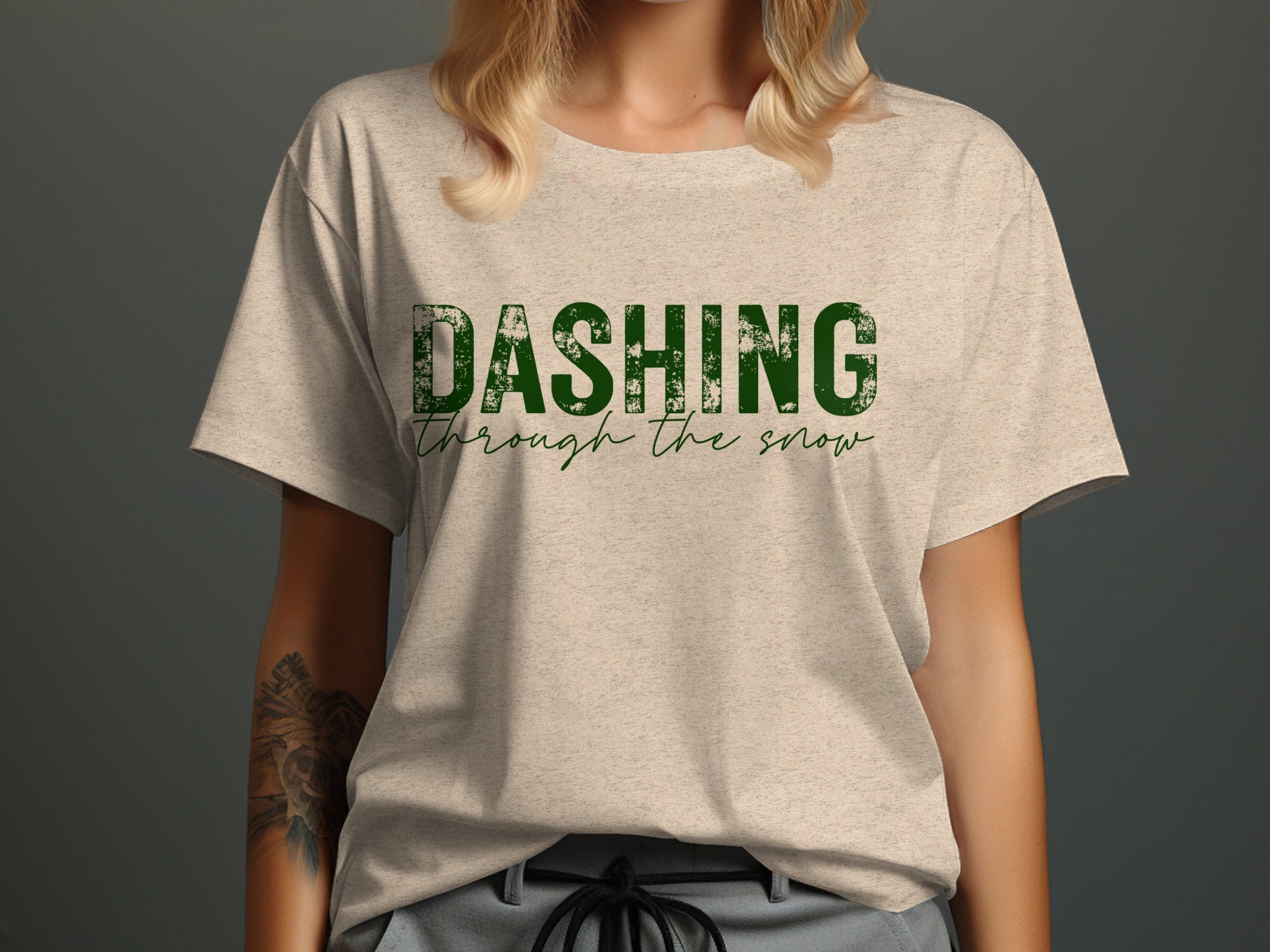 Light grey t-shirt with green text "DASHING through the snow"