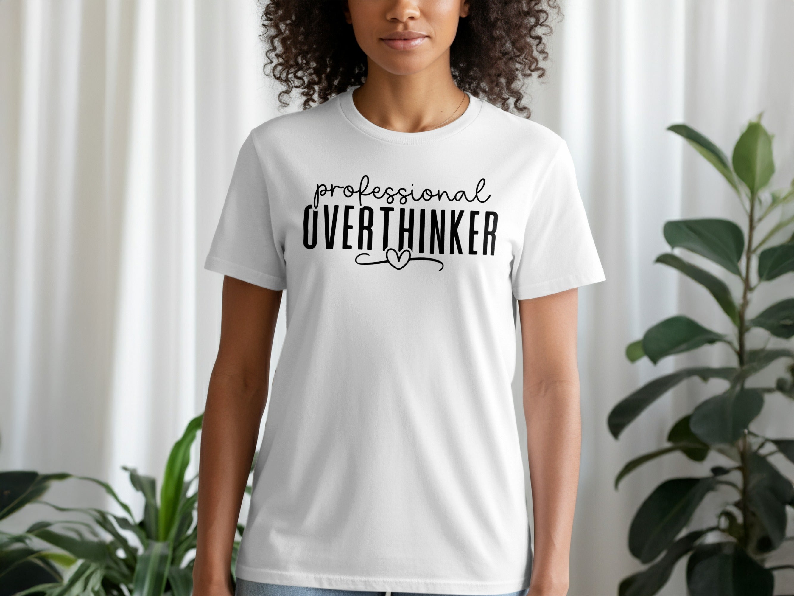 White t-shirt with black text that reads "professional OVERTHINKER" with a heart.