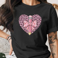 Black t-shirt with pink leopard heart, pencil, and bow graphic.