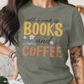 Green t-shirt with text "all i need is BOOKS and COFFEE" and floral graphics