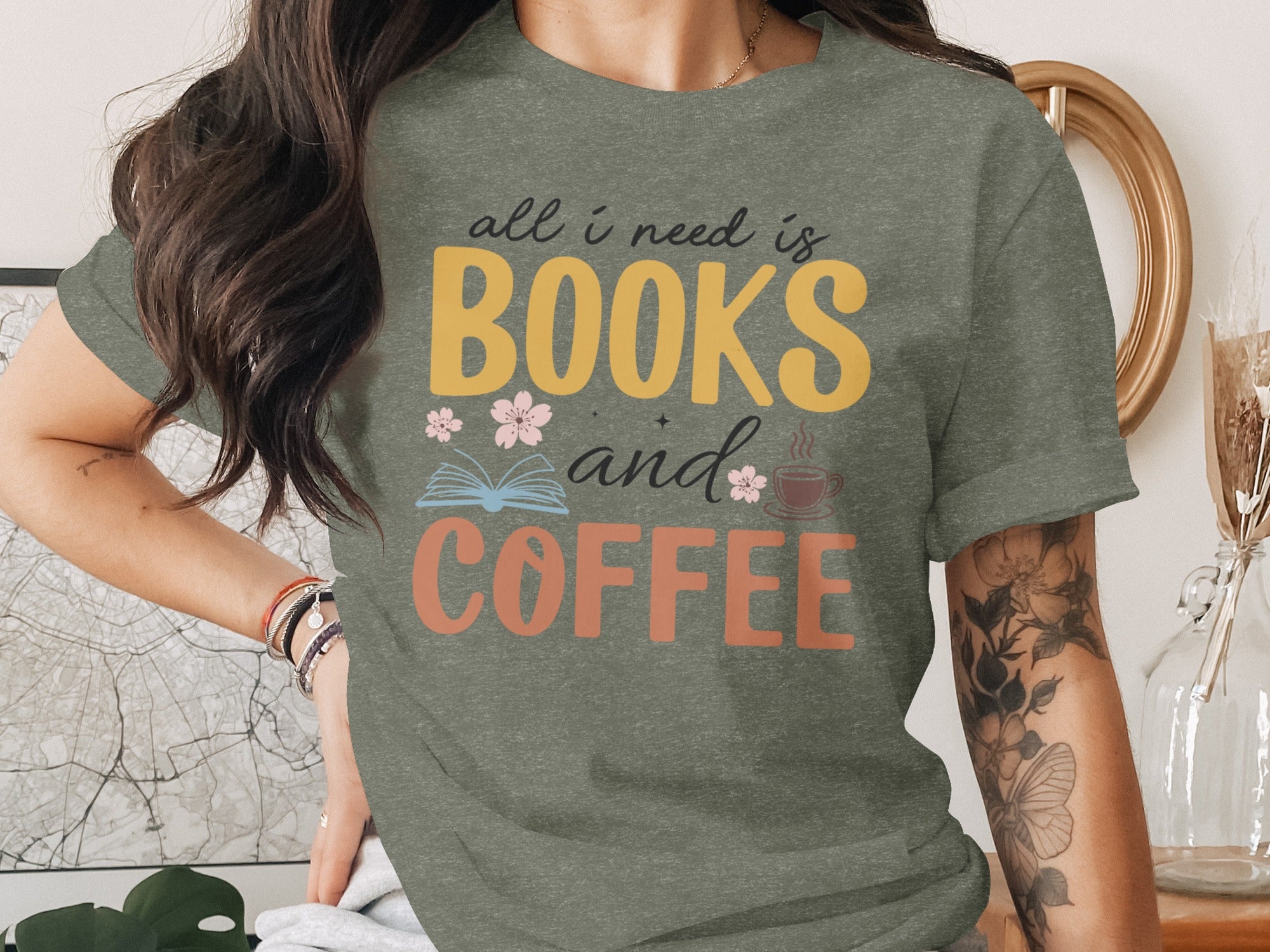 Green t-shirt with text "all i need is BOOKS and COFFEE" and floral graphics