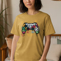 Yellow t-shirt with graffiti-style controller graphic and gaming text.