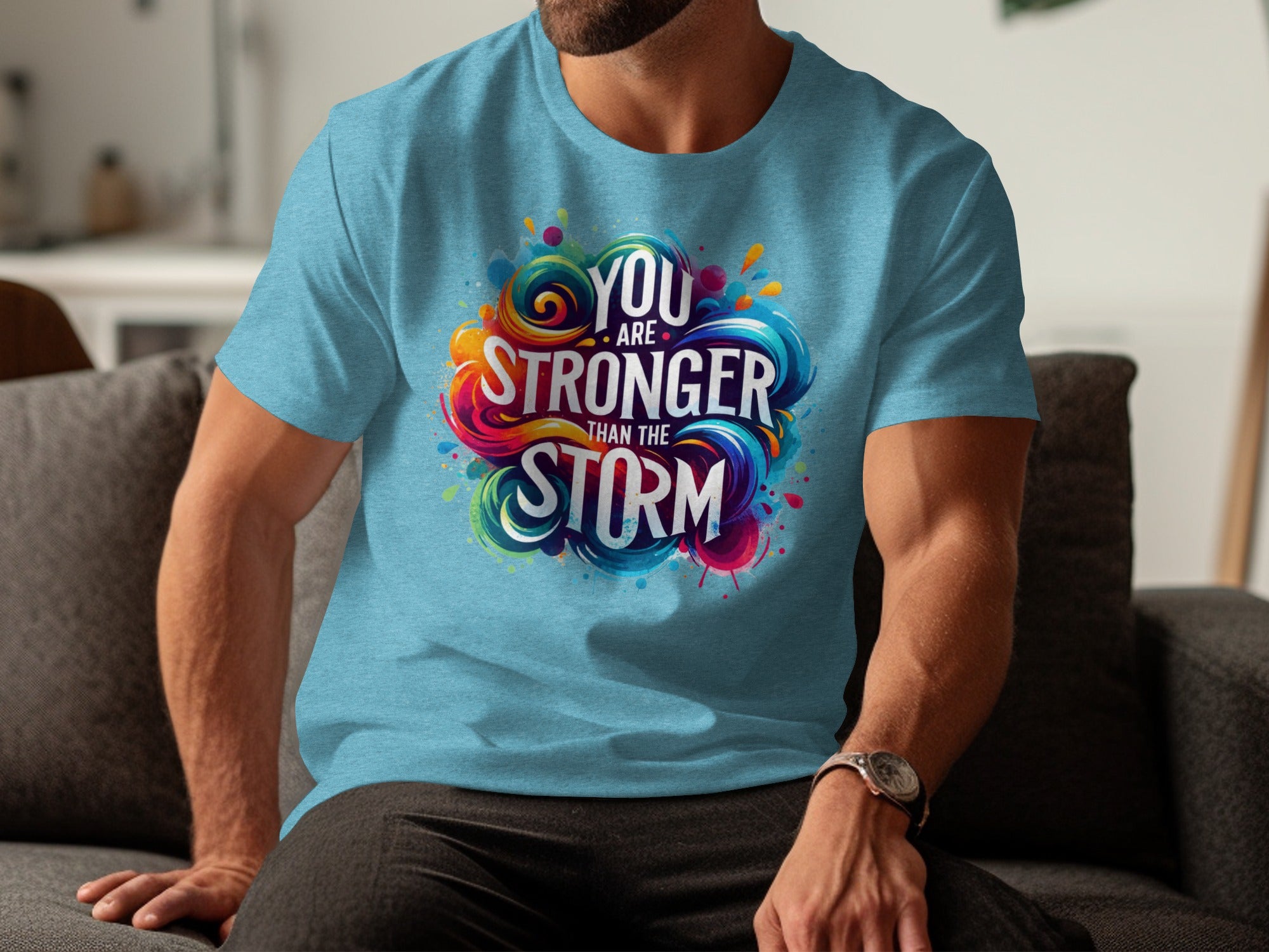 Blue t-shirt with a colorful graphic that says "You Are Stronger Than The Storm".