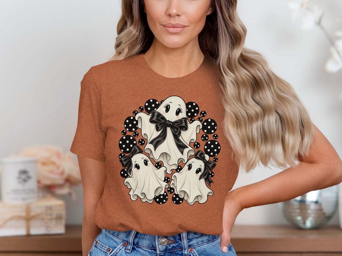 Three cute cartoon ghosts with bows surrounded by black and white polka dots.
