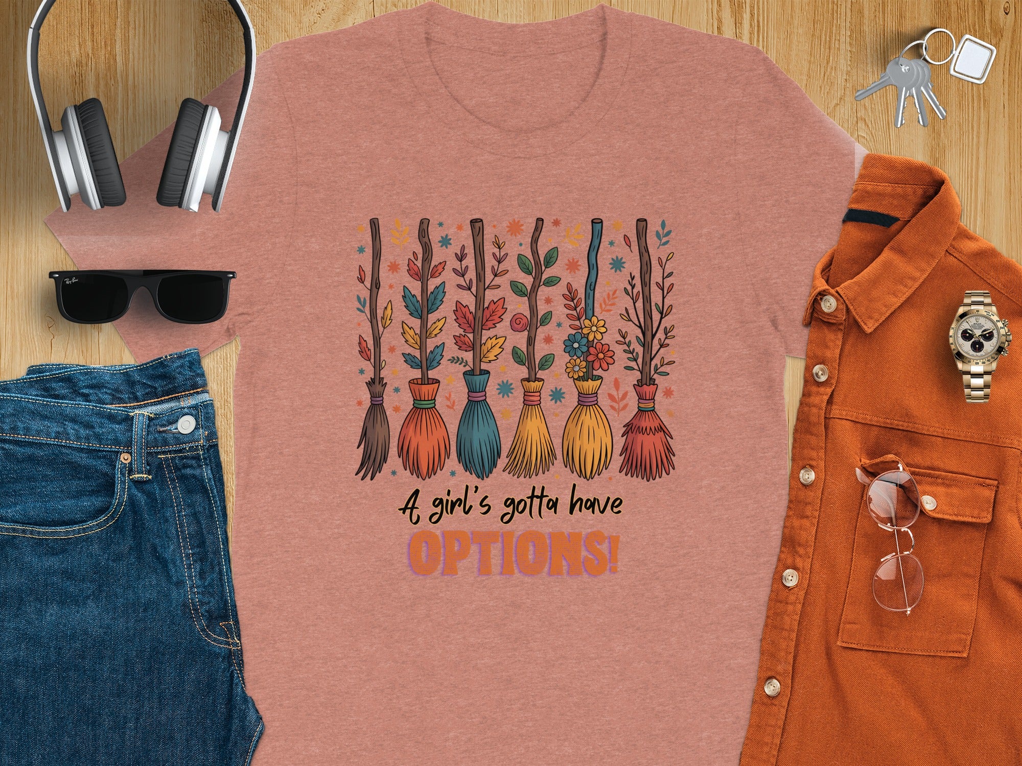 Pink t-shirt with brooms and text "A girl's gotta have OPTIONS!"