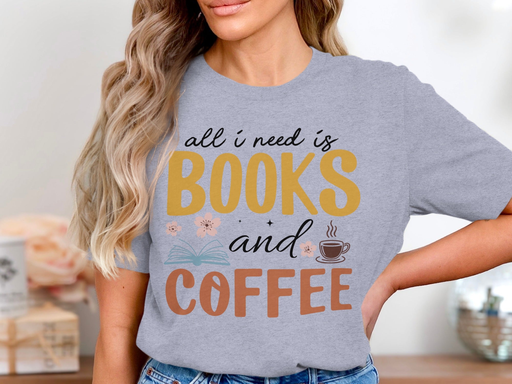 Grey t-shirt graphic: "all i need is BOOKS and COFFEE" with illustrations.