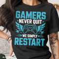 Black t-shirt with blue text: "GAMERS NEVER QUIT WE SIMPLY RESTART"