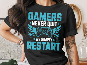 Black t-shirt with blue text: "GAMERS NEVER QUIT WE SIMPLY RESTART"
