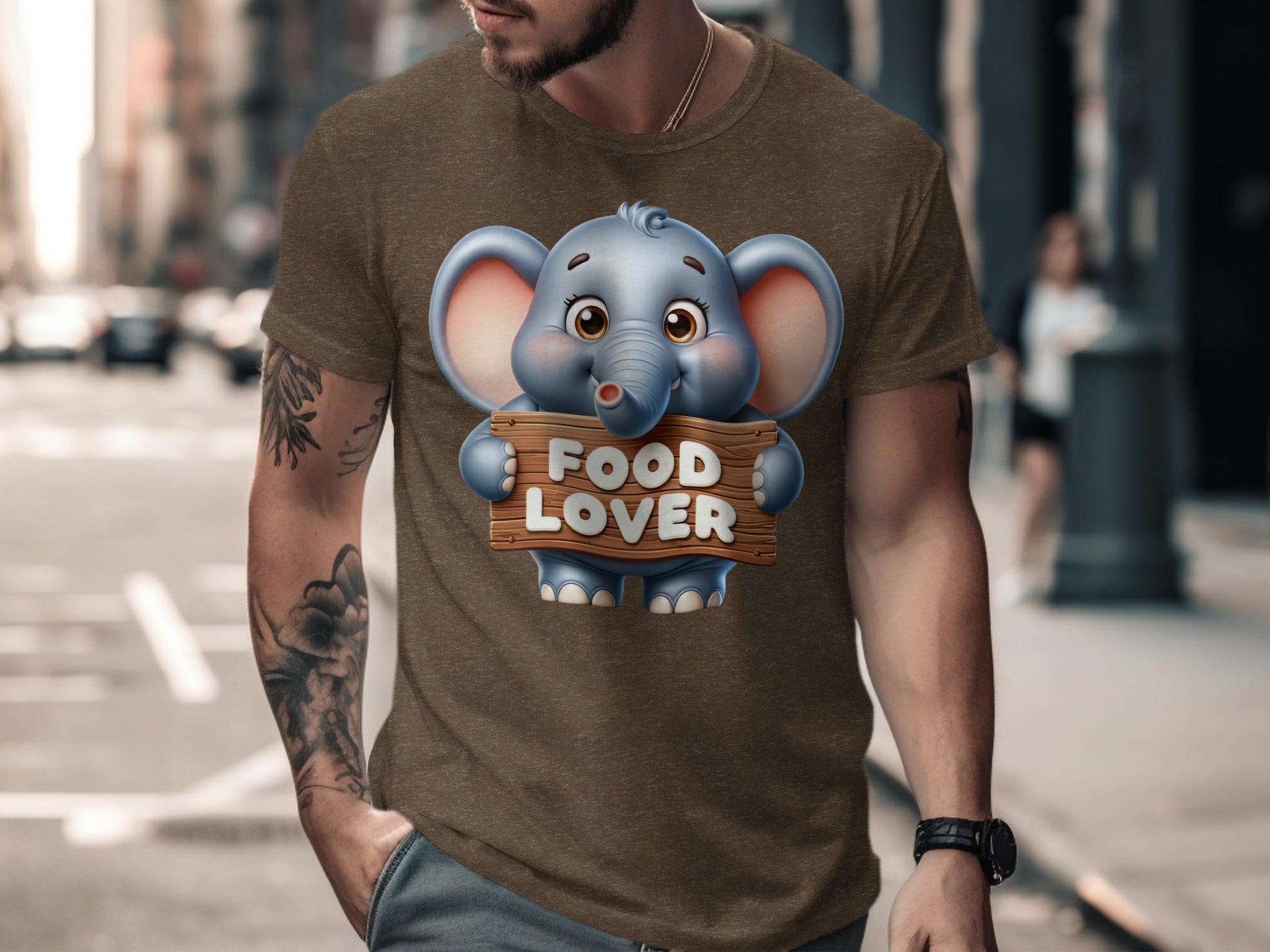 Brown t-shirt with a cartoon elephant holding a sign that says "FOOD LOVER".