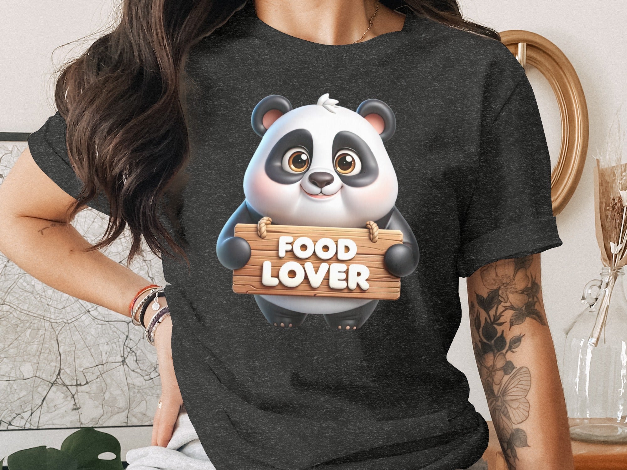 Panda holding wooden sign that says "FOOD LOVER" on a dark t-shirt.