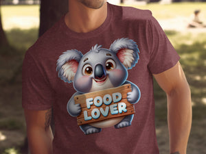 Cute cartoon koala holding a "FOOD LOVER" sign on a maroon t-shirt.