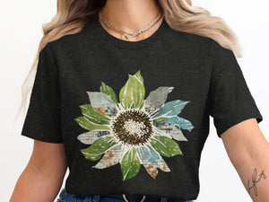Dark t-shirt with a watercolor sunflower graphic featuring brick texture.