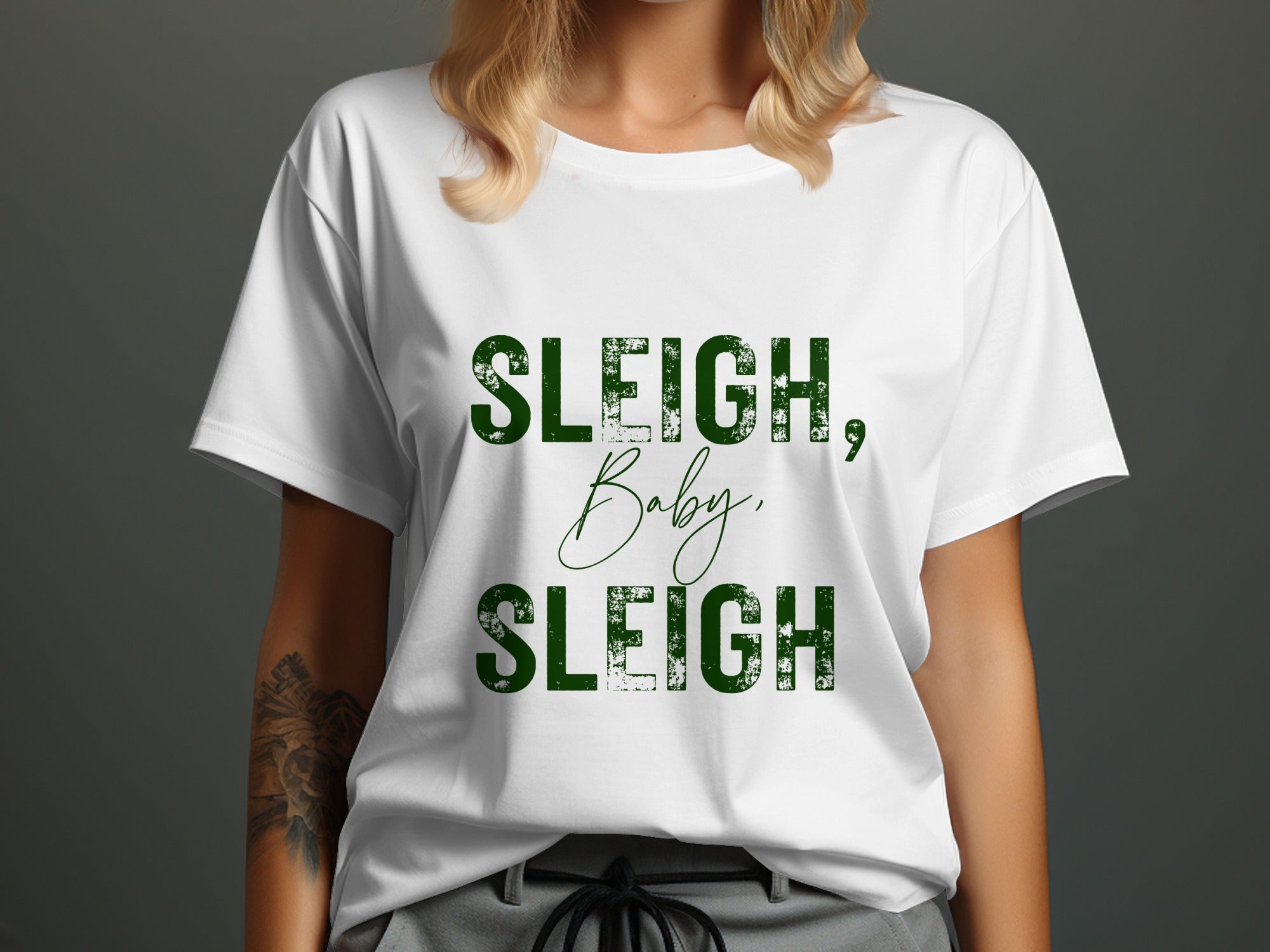 White t-shirt with green text reading "SLEIGH, Baby, SLEIGH".