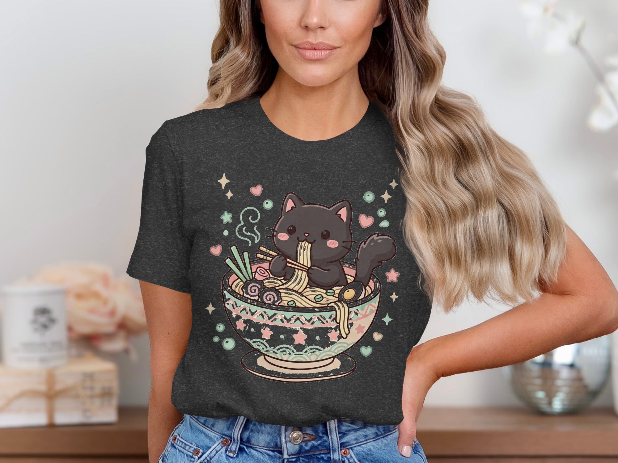 Black cat eating noodles from a decorative bowl with stars and hearts.