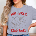 Grey t-shirt with "HOT GIRLS READ BOOKS" and a line drawing of hands writing in a book.