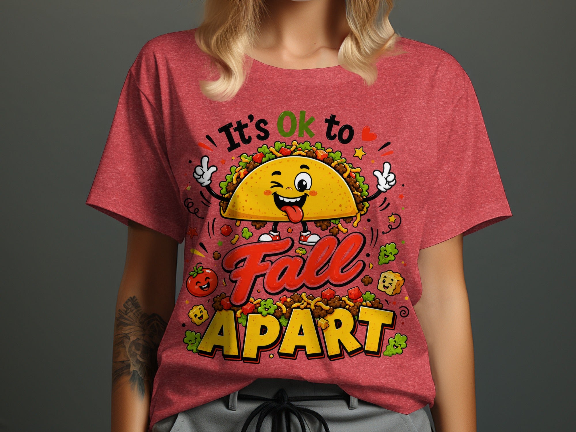 T-shirt graphic with cartoon taco and text "It's Ok to Fall APART".