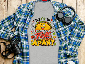 Grey t-shirt with "It's Ok to Fall Apart" text and cartoon taco graphic.