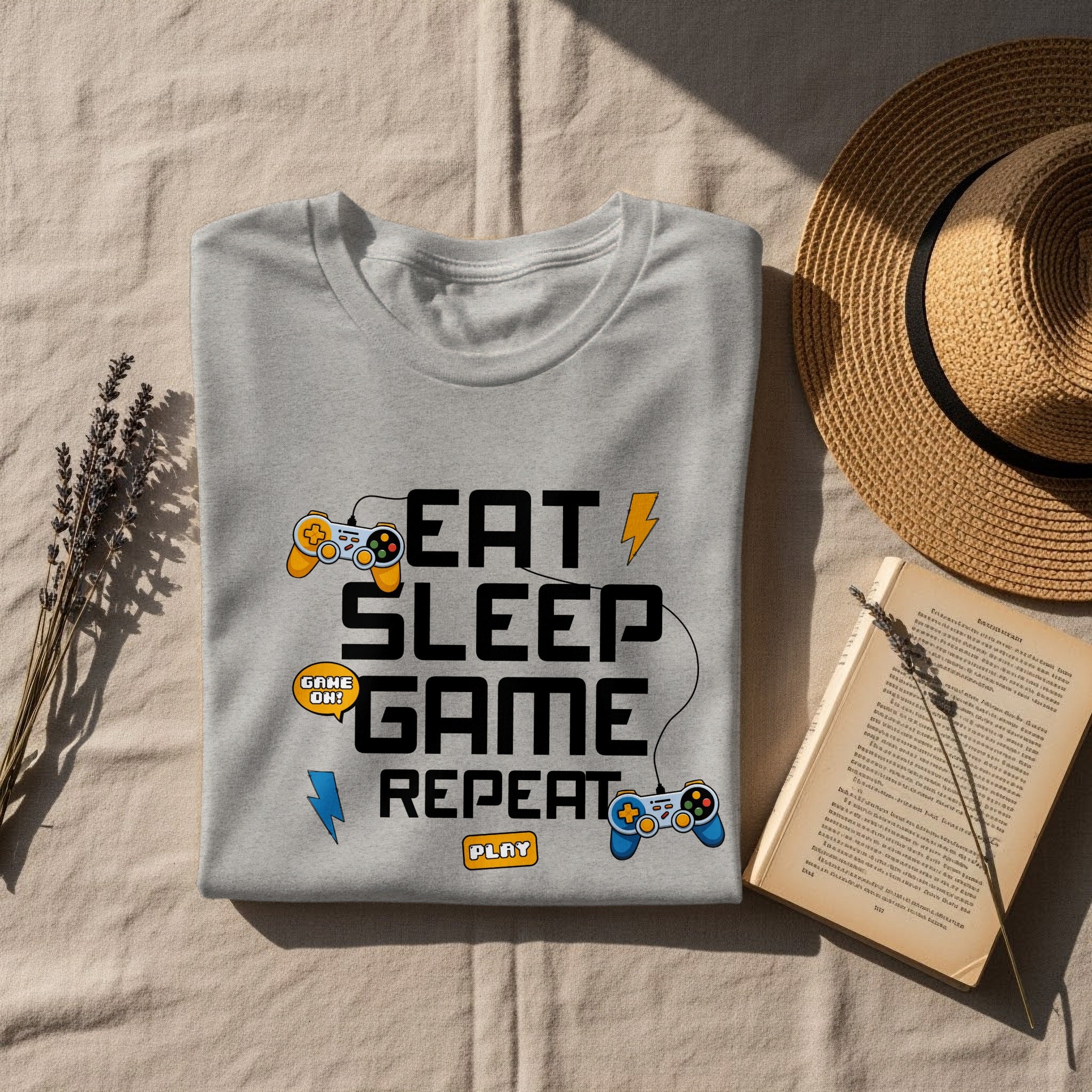 Grey t-shirt with "Eat Sleep Game Repeat" text and gaming icons.