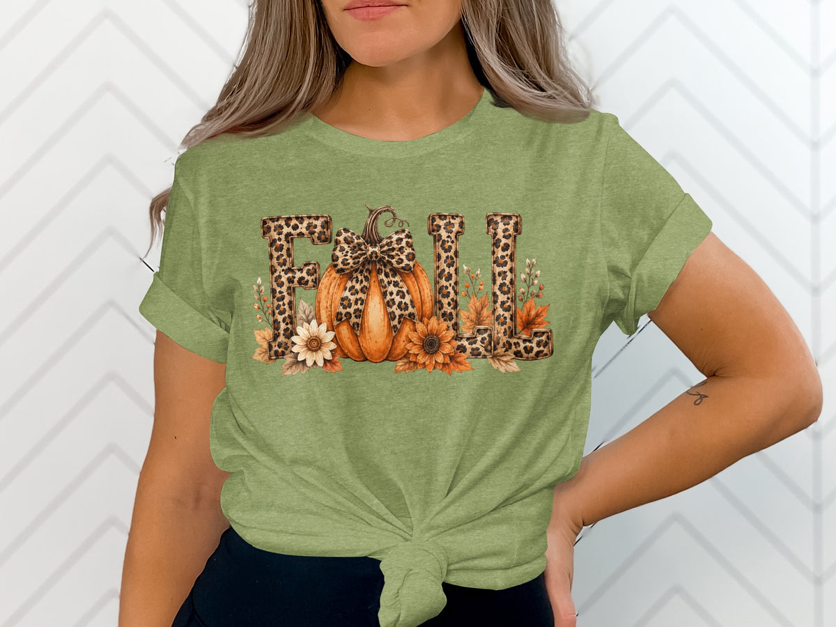 Green t-shirt with "FALL" text featuring leopard print letters, a pumpkin, and autumn flowers.