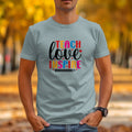 Teach love inspire text with pencil graphic on a light blue t-shirt.