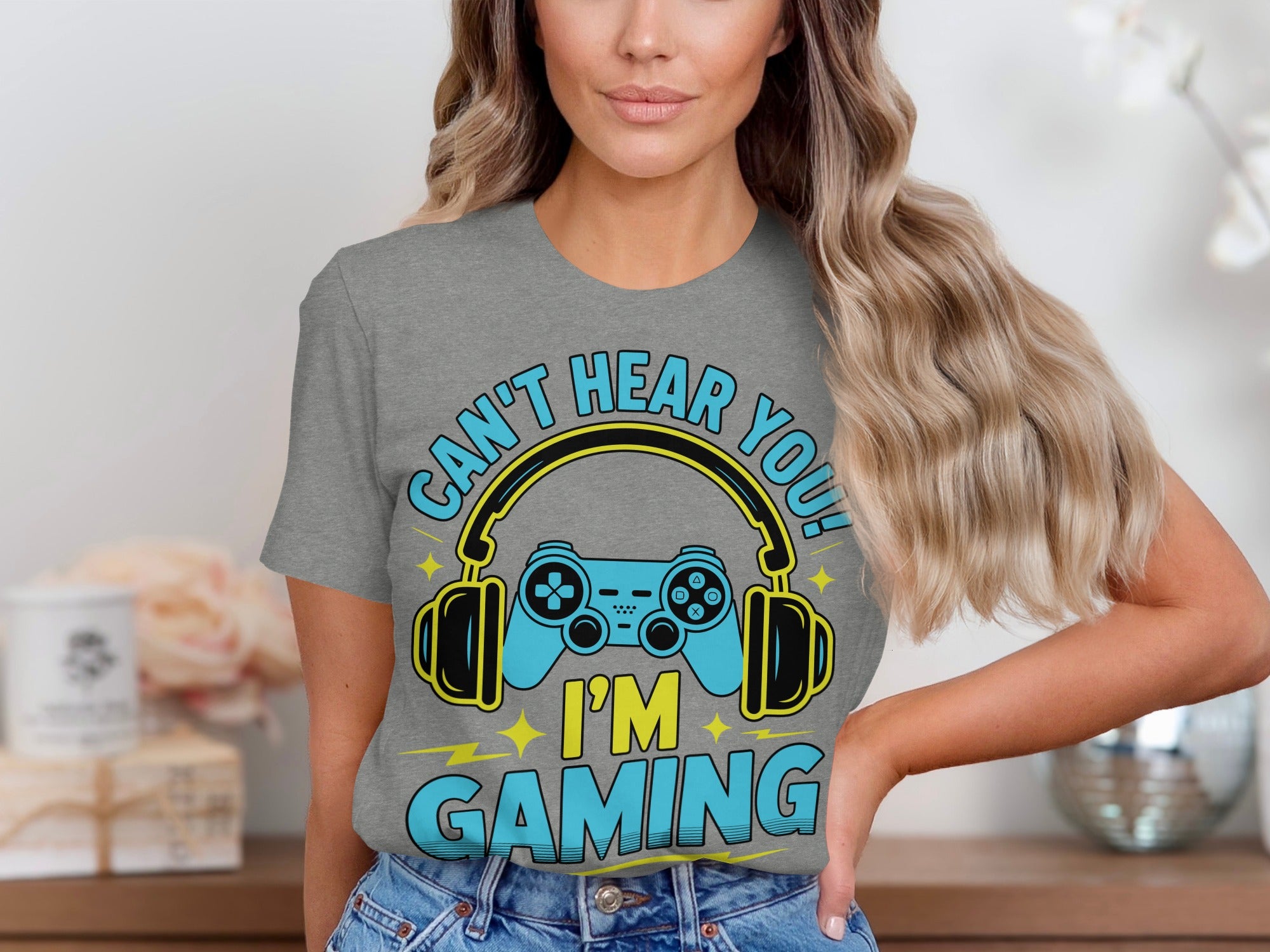 Gray t-shirt with blue and yellow text and graphics saying "Can't Hear You! I'm Gaming".
