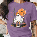 Ghost on a swing with a large moon and bats.