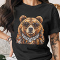 Black t-shirt with a bear wearing leopard print sunglasses and a diamond necklace.