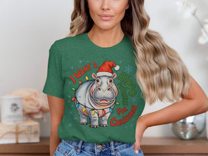 Green t-shirt with cartoon hippo wearing Santa hat and Christmas lights, saying "I Want A Hippo Christmas".