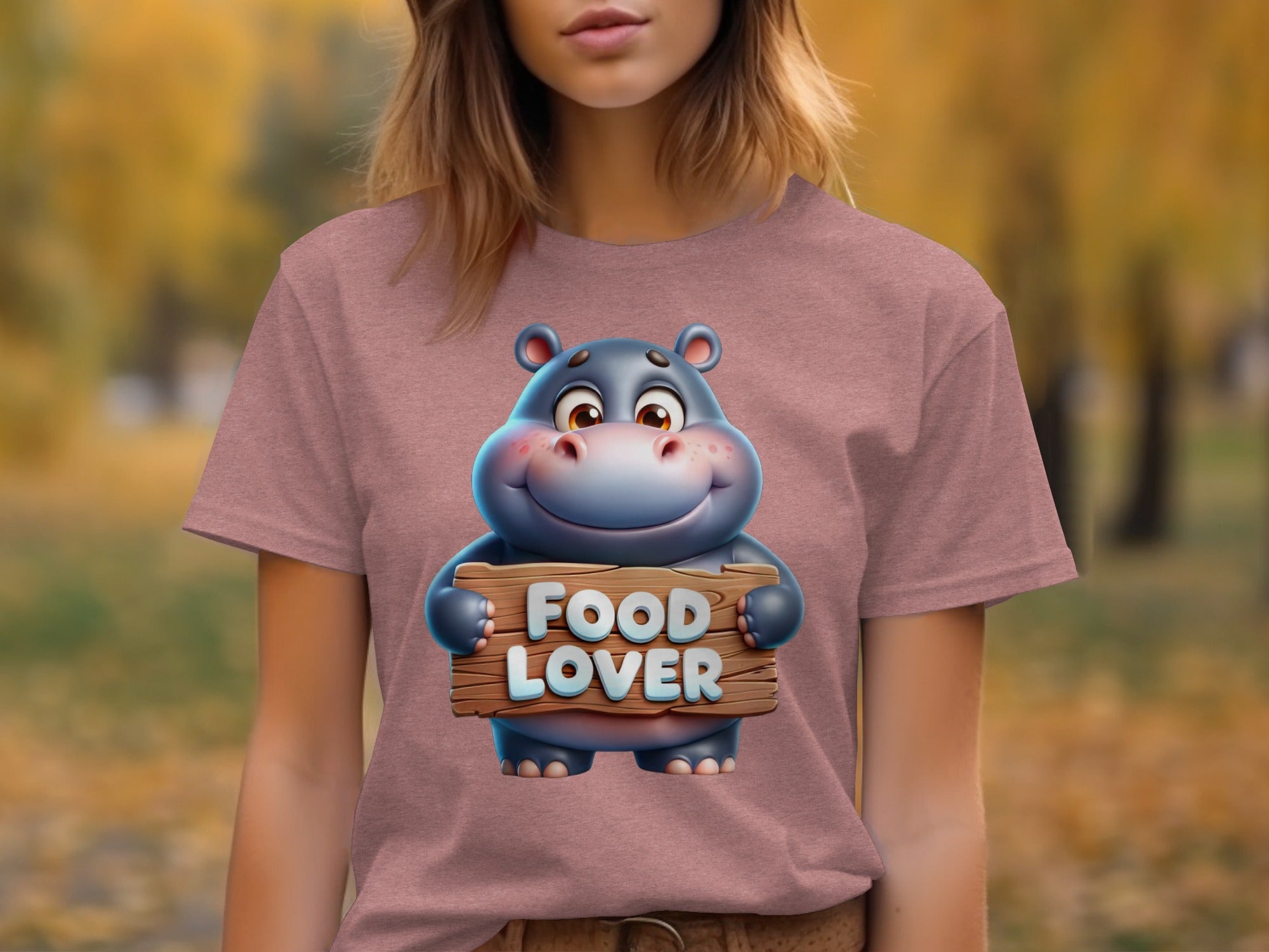 Cartoon hippo character on a pink t-shirt holding a wooden sign that says "FOOD LOVER".